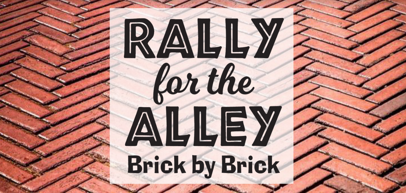 Logo saying "Rally for the Alley - Brick by Brick" on a brick background
